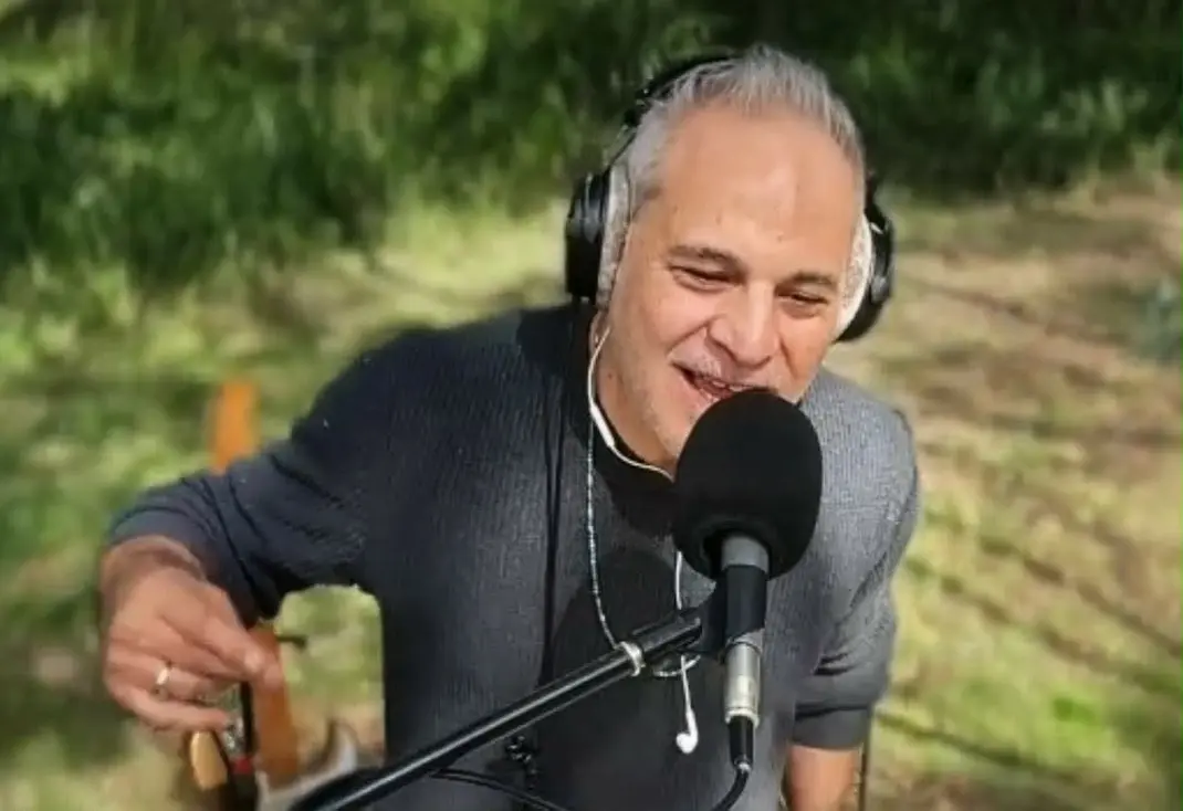 Sam Cutri singing and performing live through headphones and microphone