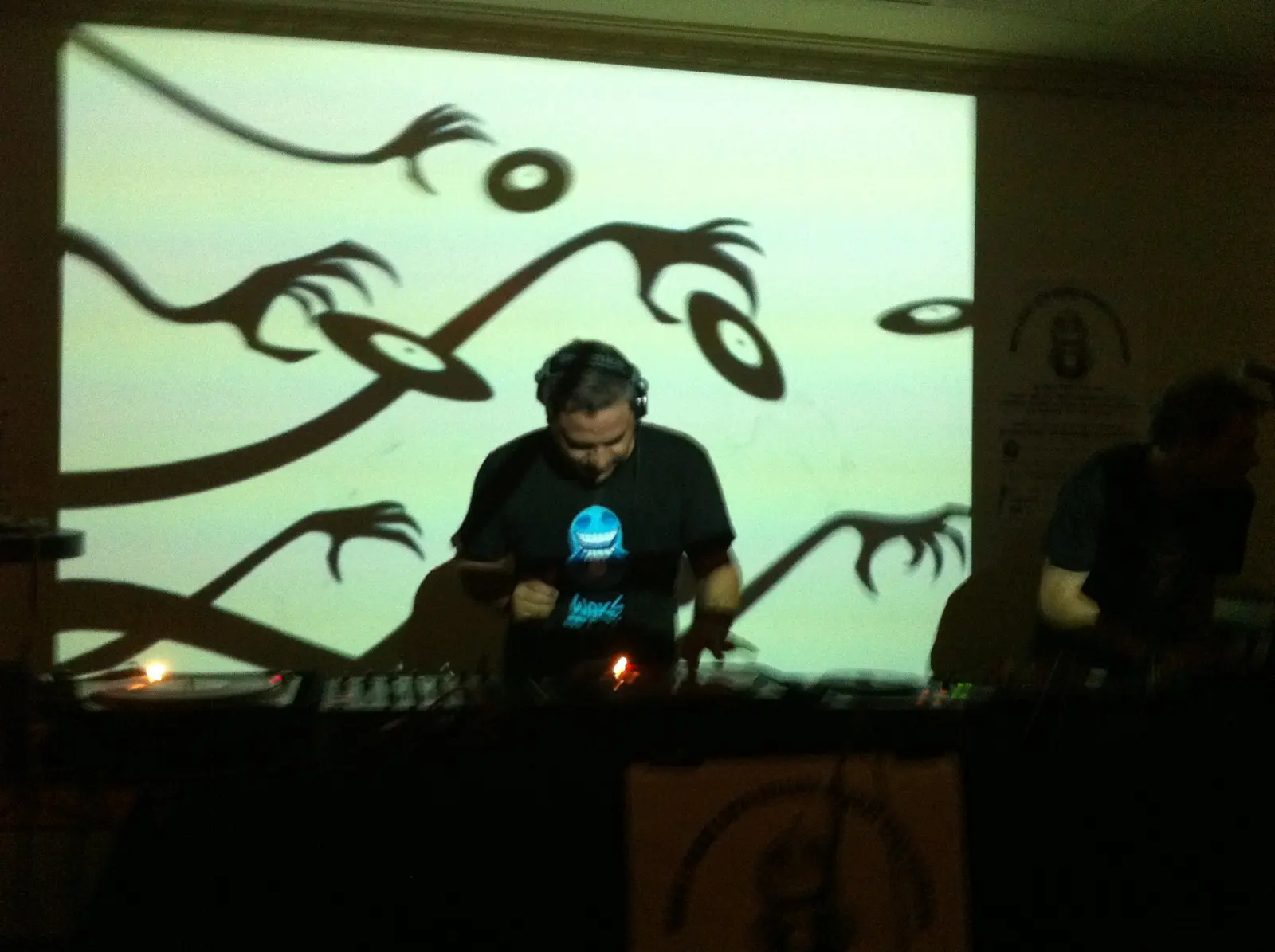 Sam Cutri performing electronic music in front of projected animation