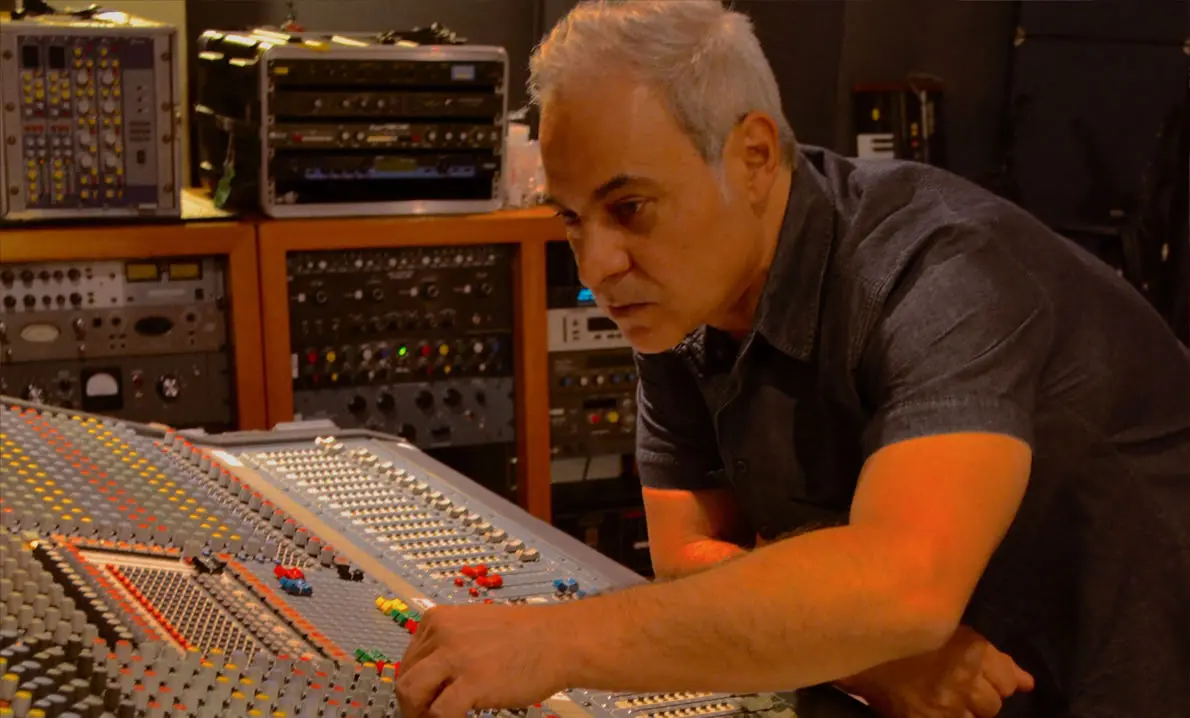 Sam Cutri producing music at a professional recording console