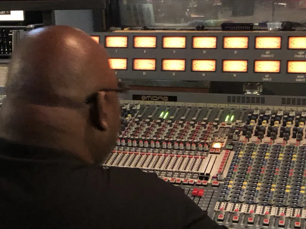 Engineer working at a large analogue recording console