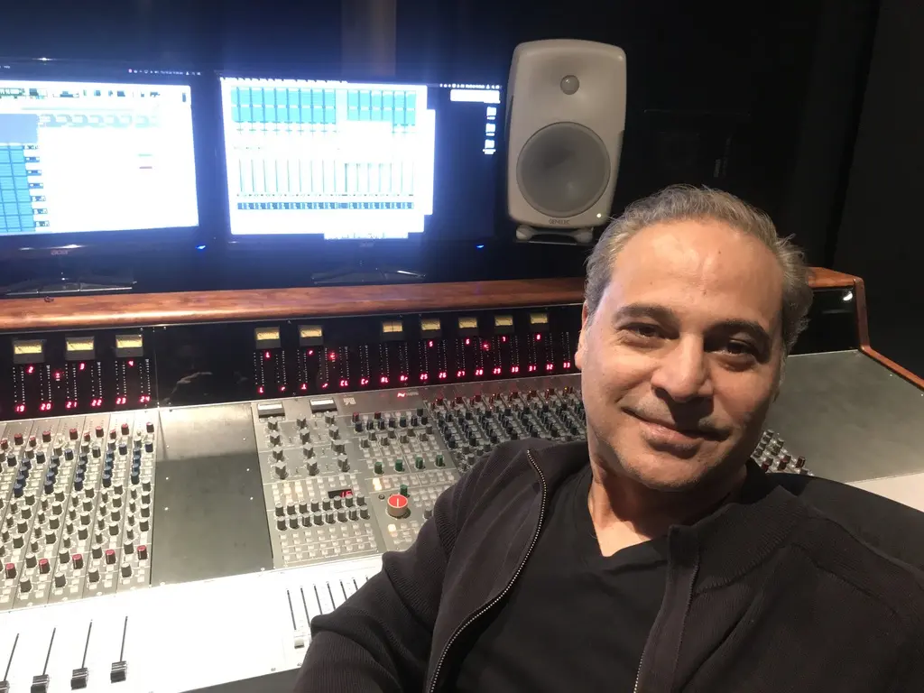 Sam Cutri seated at a professional recording console during a studio session