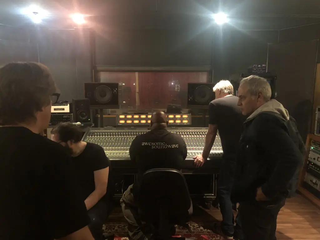 Sam Cutri and collaborators working around a large-format recording console